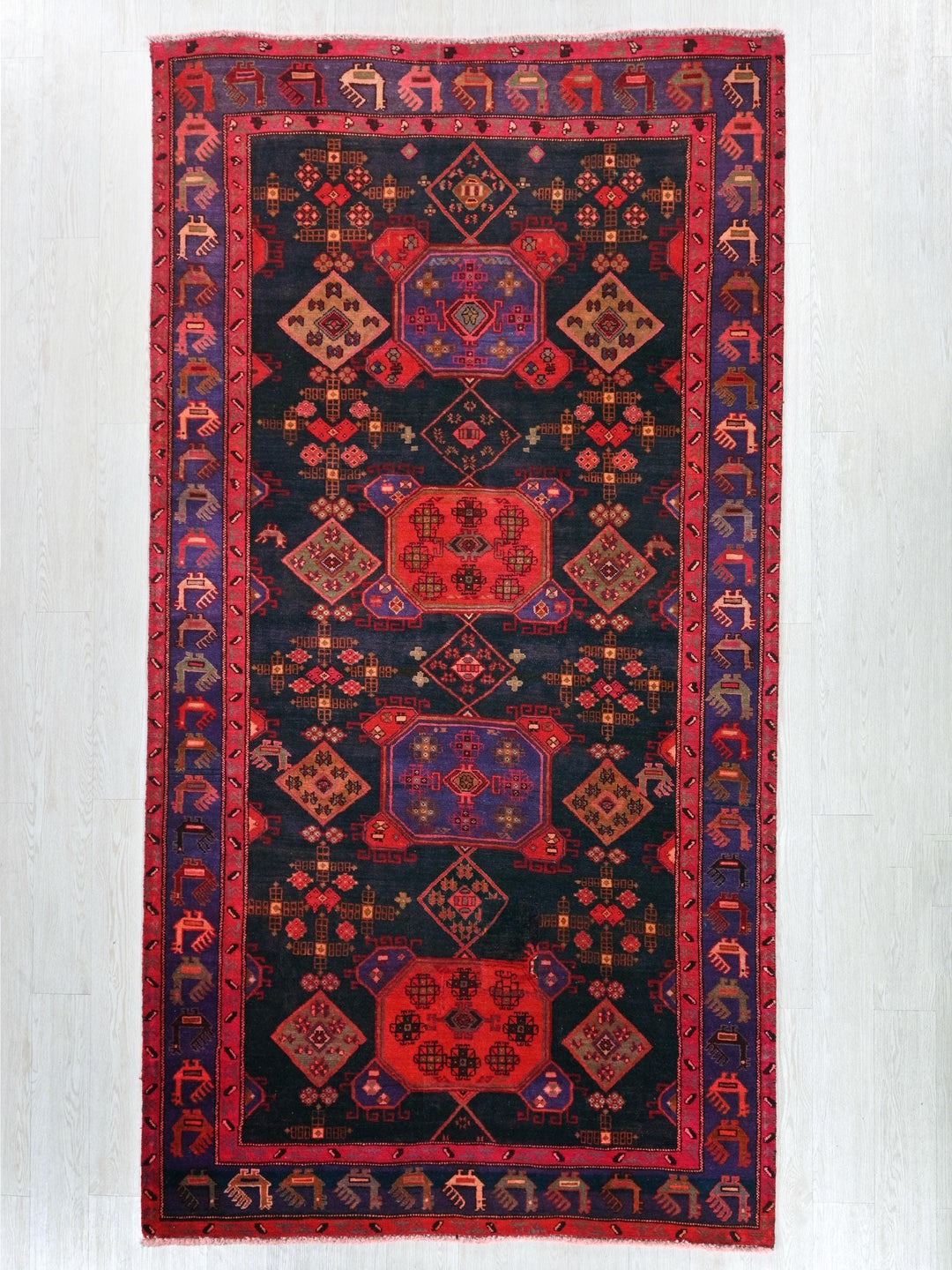 a black rug with red and blue designs on it
