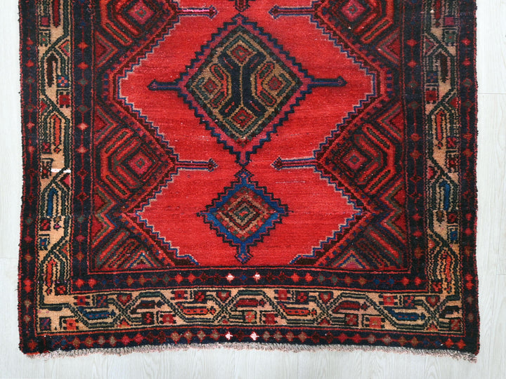 a red rug with a diamond pattern on it