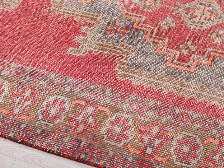 a close up of a rug on a wooden floor