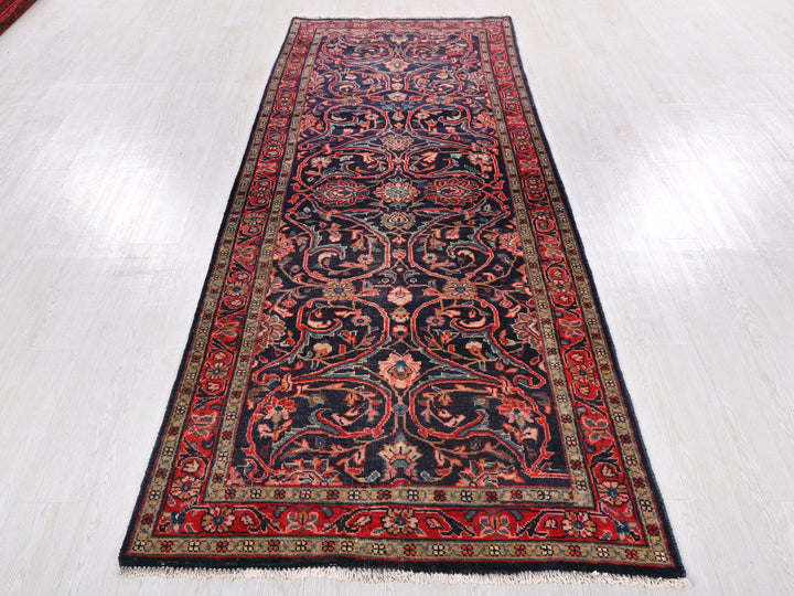 a red and black rug on a white floor