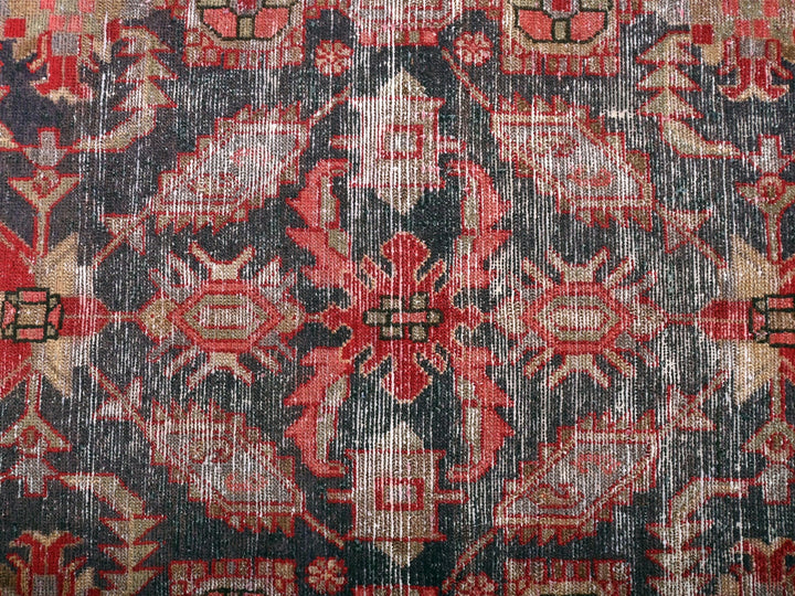a red and black rug with a pattern on it