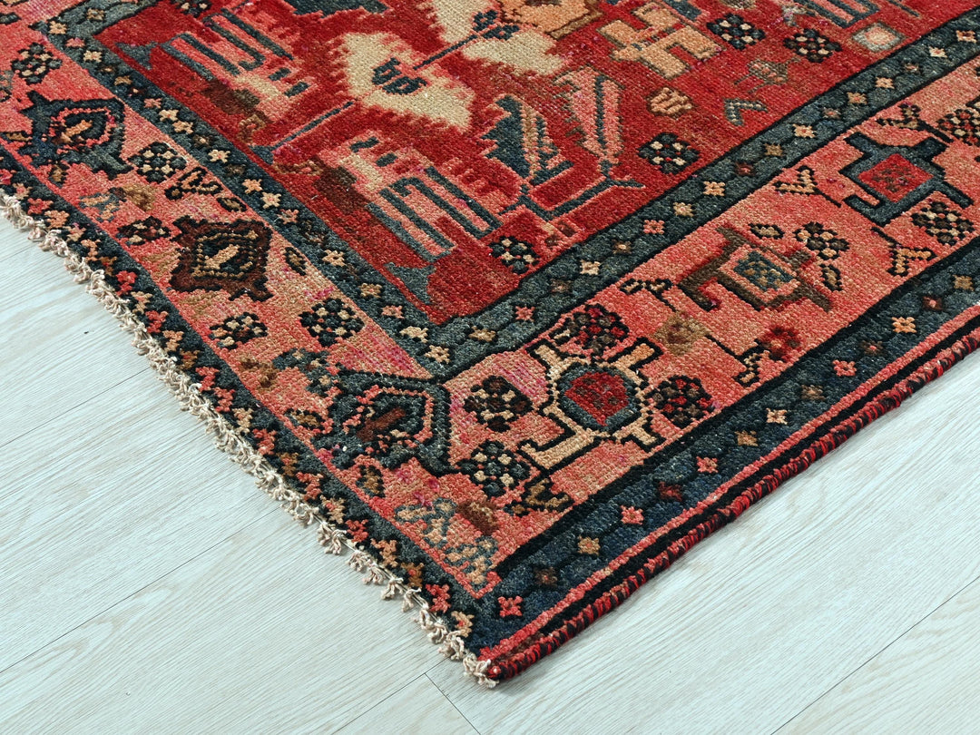 a red and blue rug on a white floor