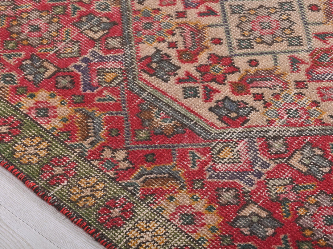 a close up of a rug on a wooden floor