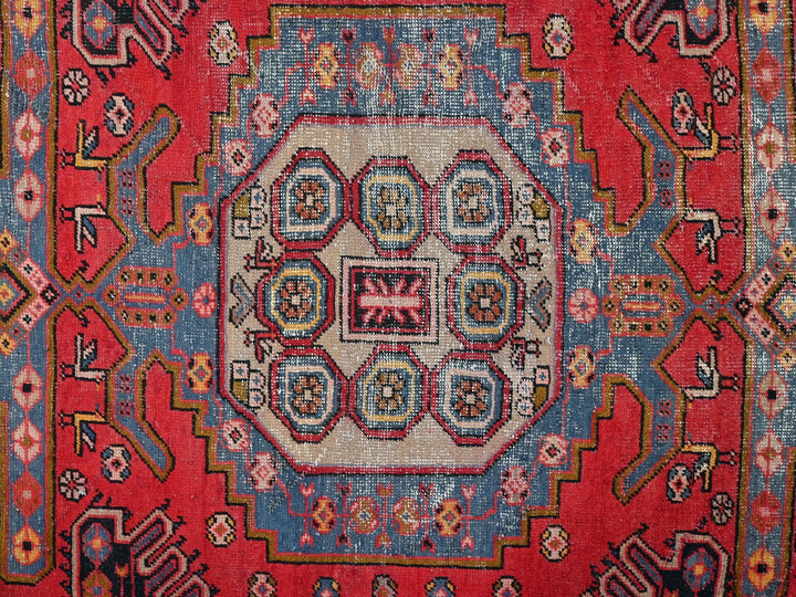a red rug with a circular design on it