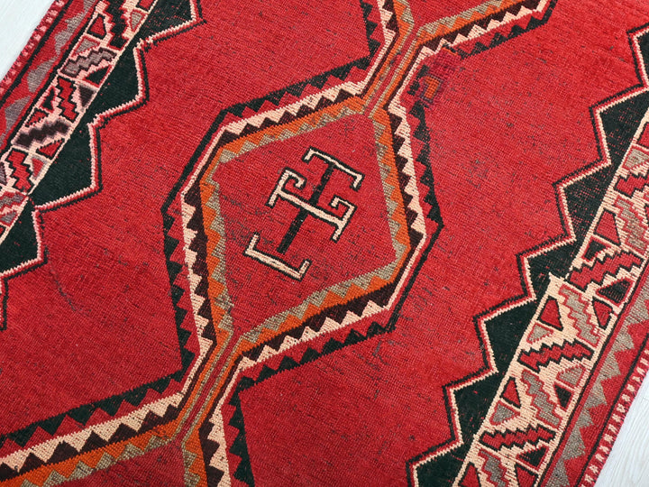 a close up of a red rug on the floor