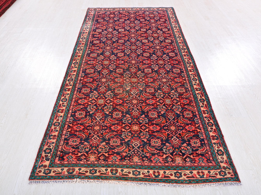 a red and blue rug on a white floor