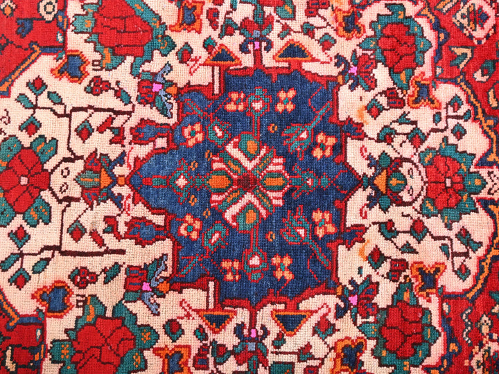 a red and blue rug with a floral design