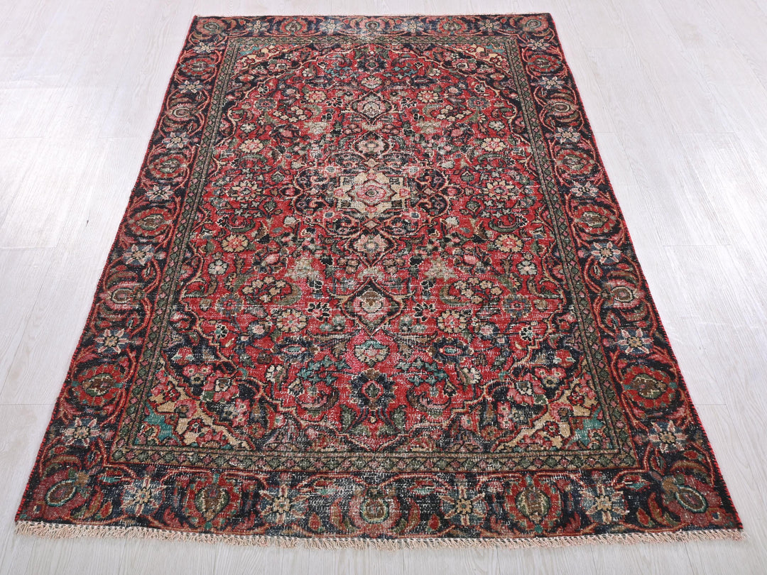 a red and blue rug on a white floor