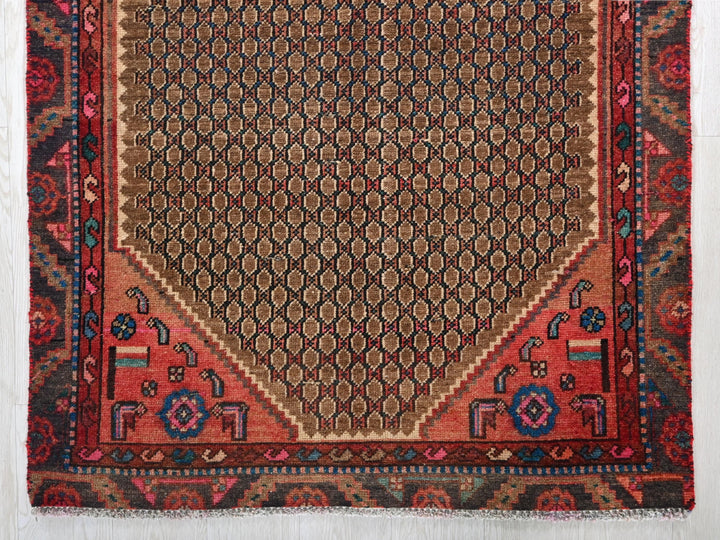 a red rug with an intricate design on it