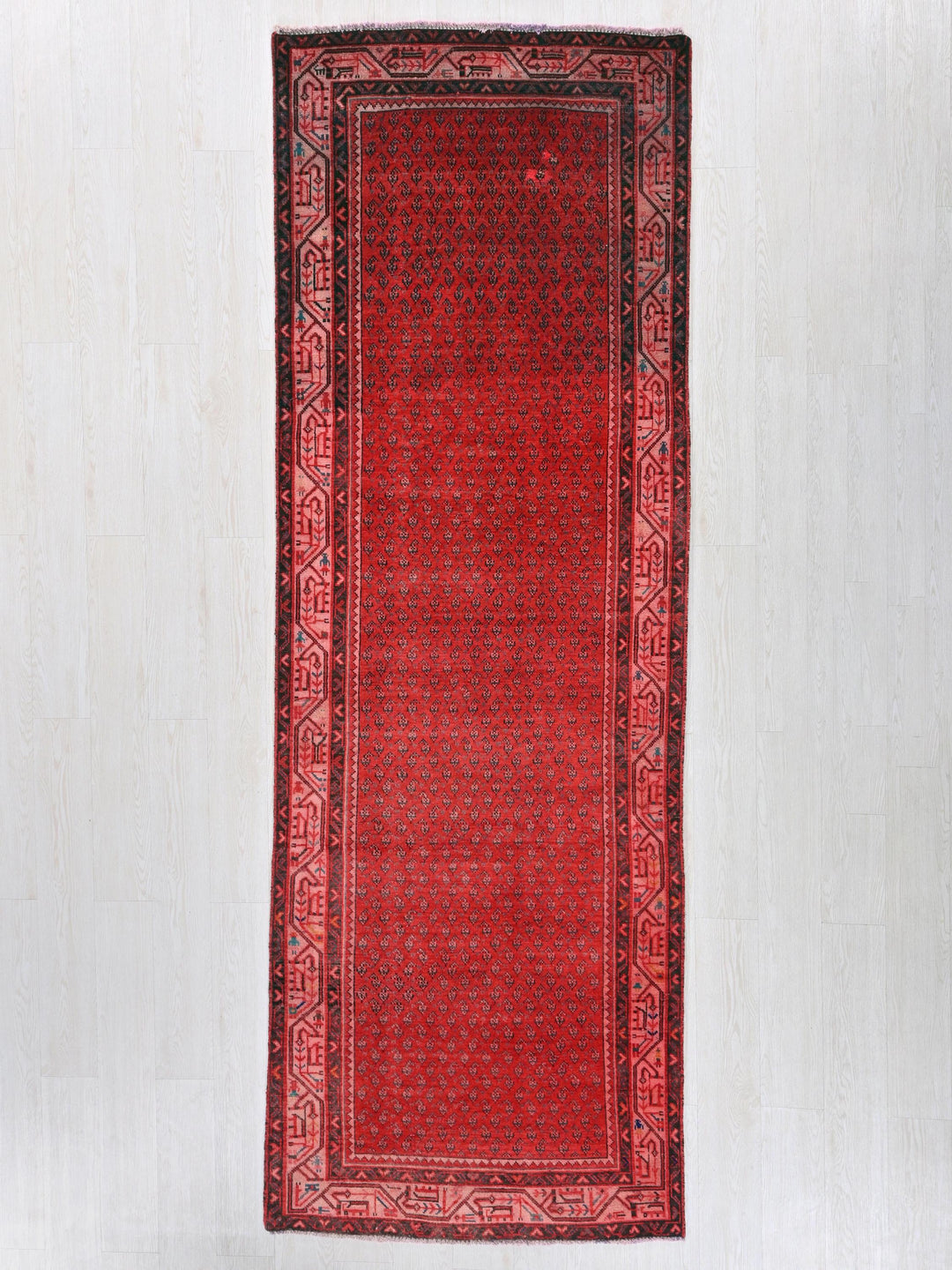 a red rug hanging on a wall