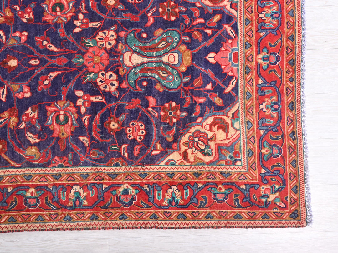 a blue rug with a red border on a white floor