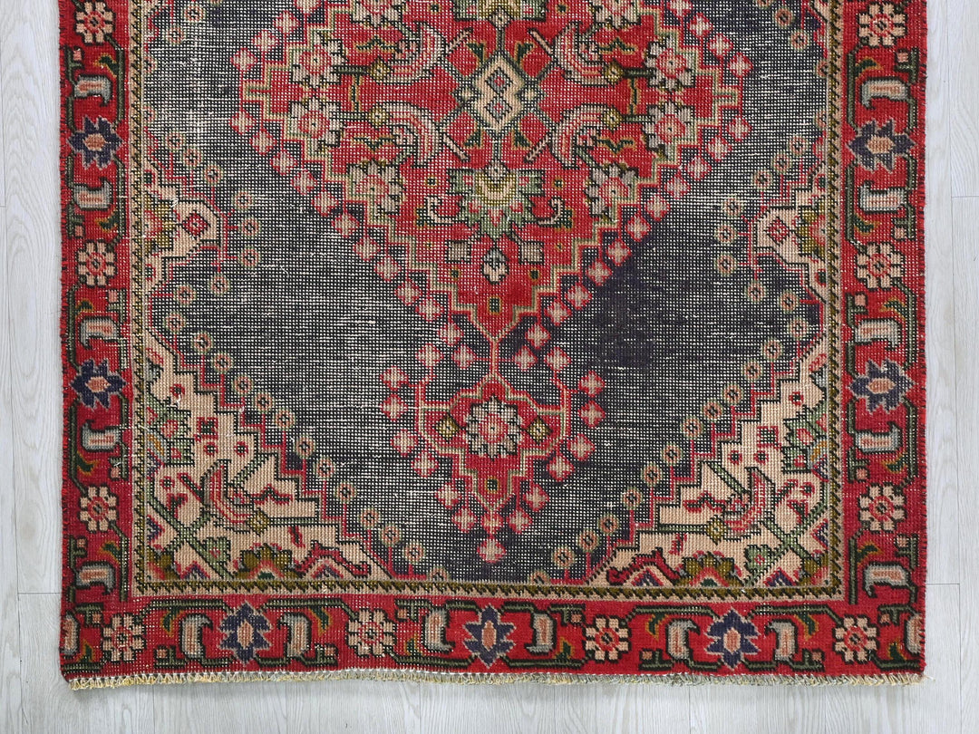 a red and blue rug on a white floor