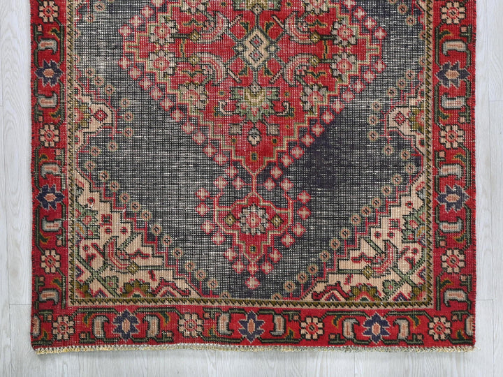 a red and blue rug on a white floor