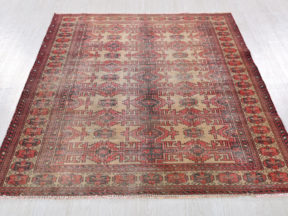 a red and beige rug on a white floor