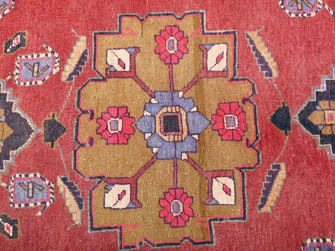 a close up of a rug with a red background