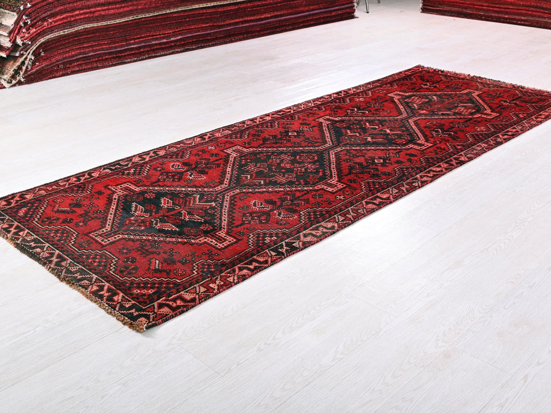 a red rug is laying on a white floor