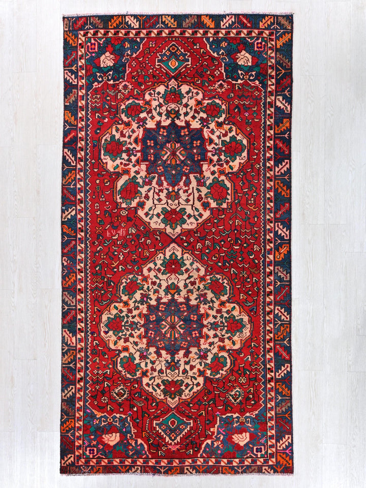 a red and blue rug with an intricate design