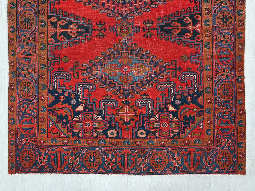 a red rug with a blue and red design