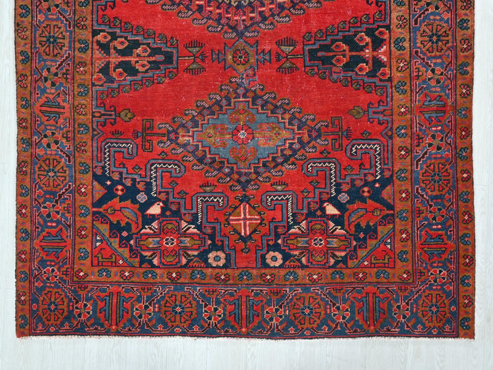 a red rug with a blue and red design