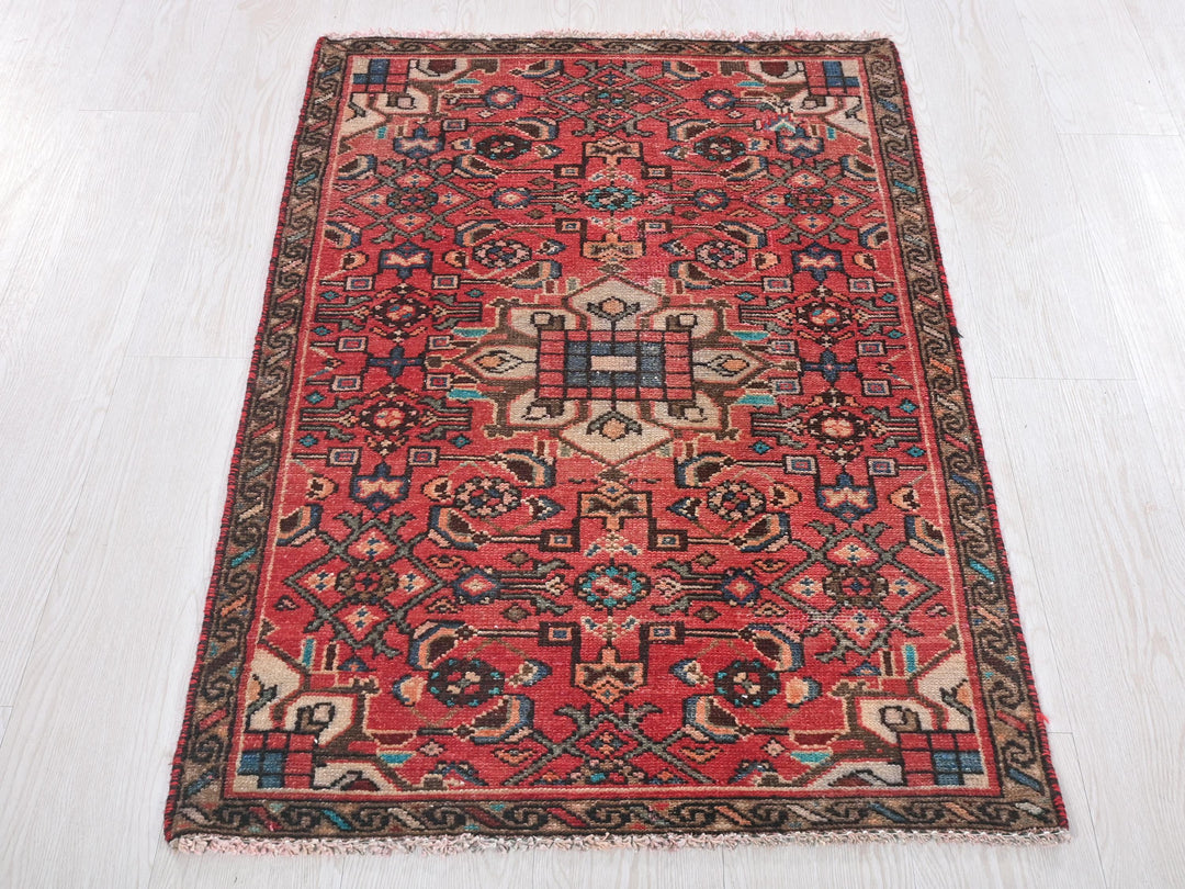 a red rug on a white floor in a room