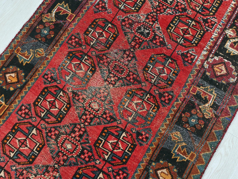 a red rug with many different designs on it