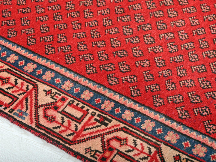 a close up of a red rug on the floor