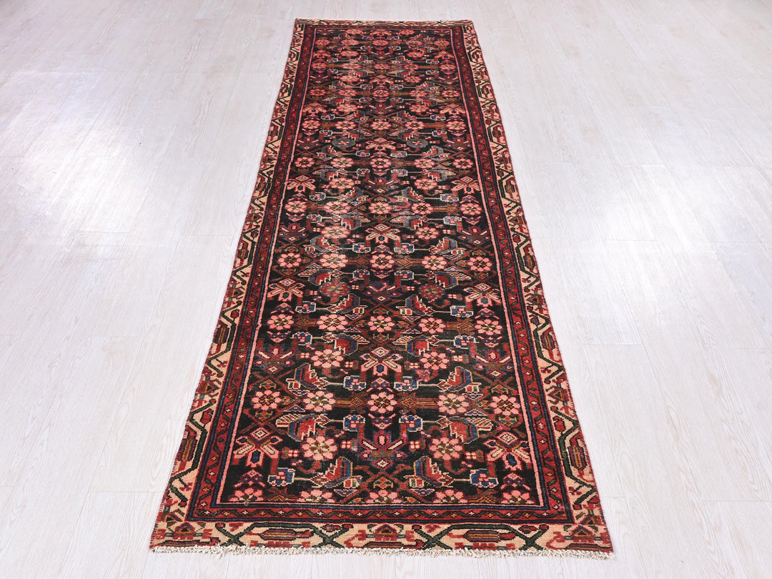 a red and black rug on a white floor