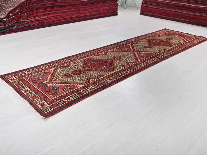 a pile of red rugs sitting on top of a white floor