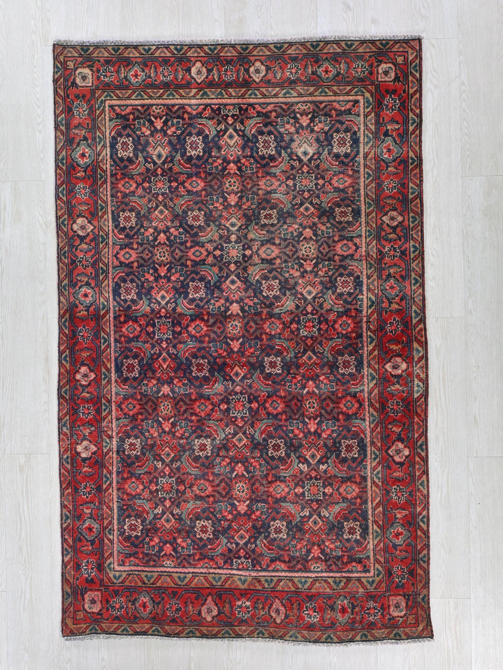 a red and blue rug on a white floor