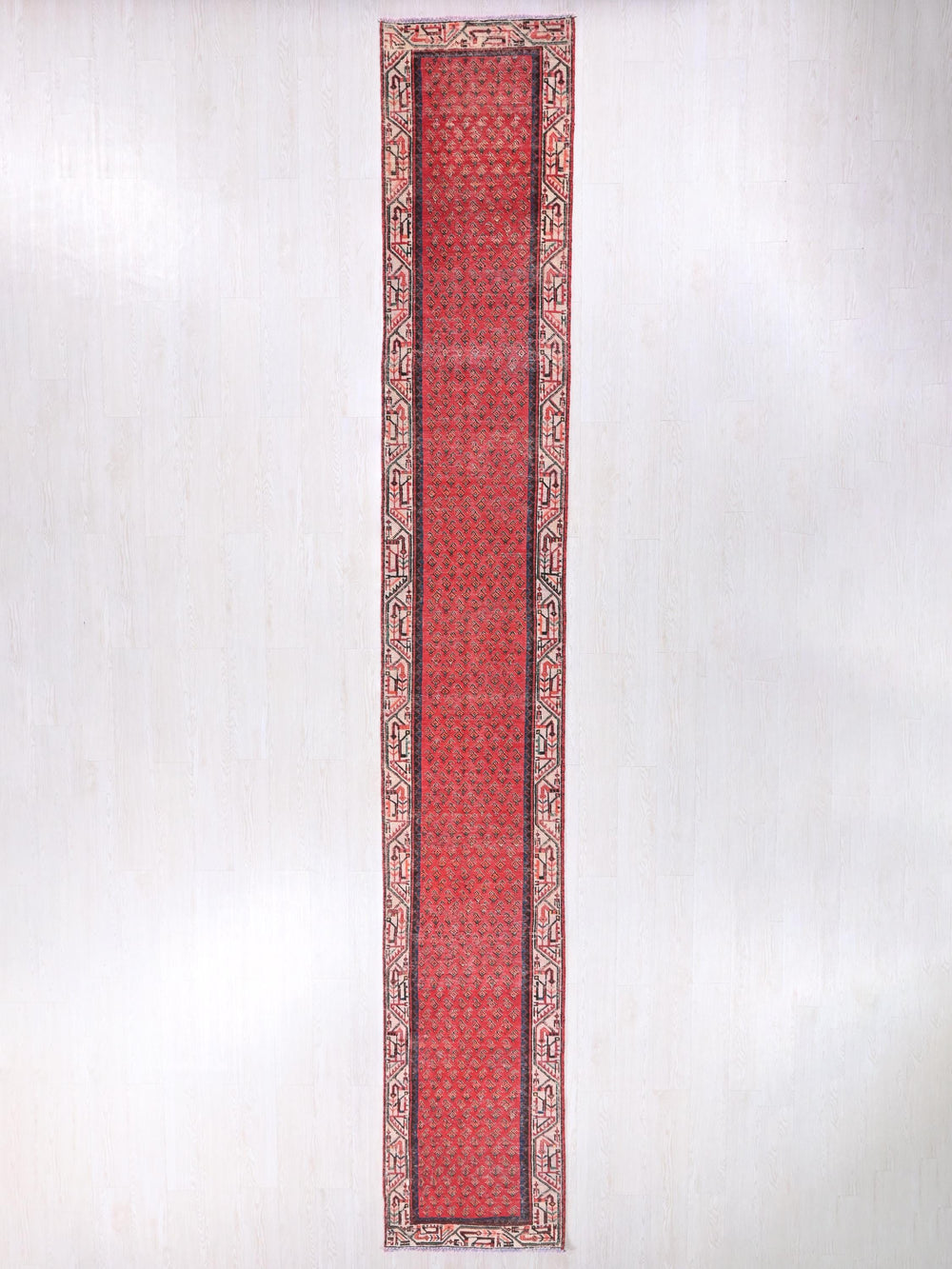 a red rug hanging on a wall in a room