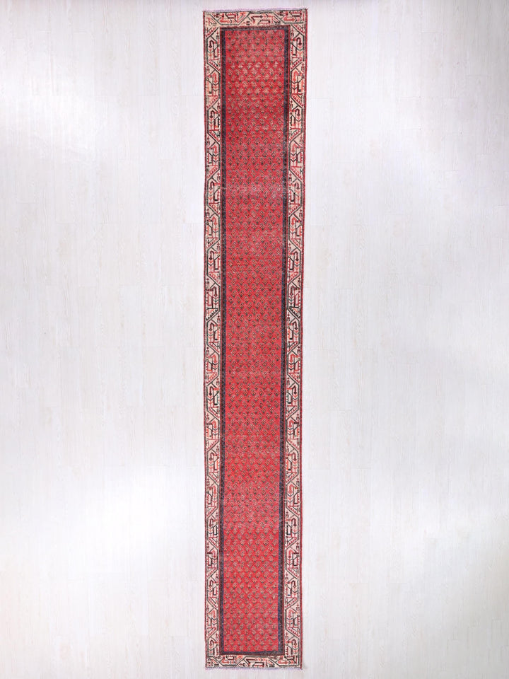 a red rug hanging on a wall in a room