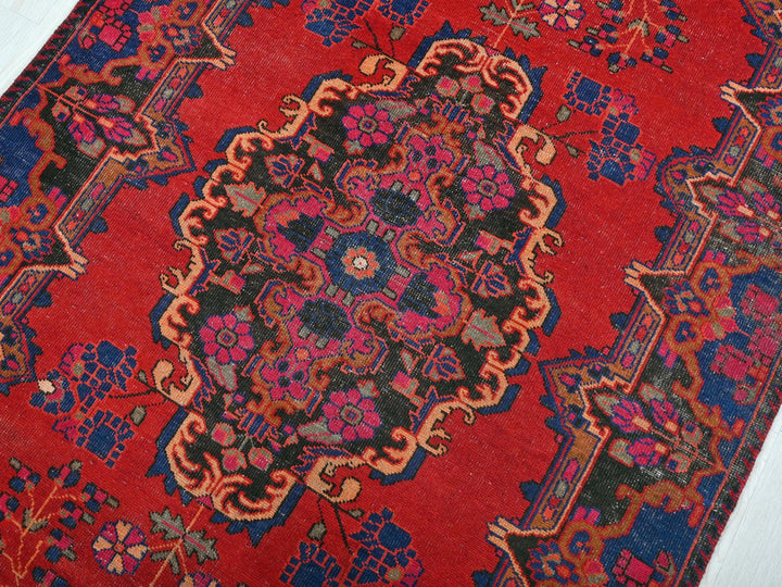 a red rug with a colorful design on it