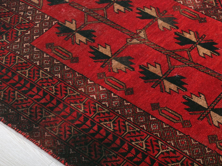 a close up of a red rug on the floor