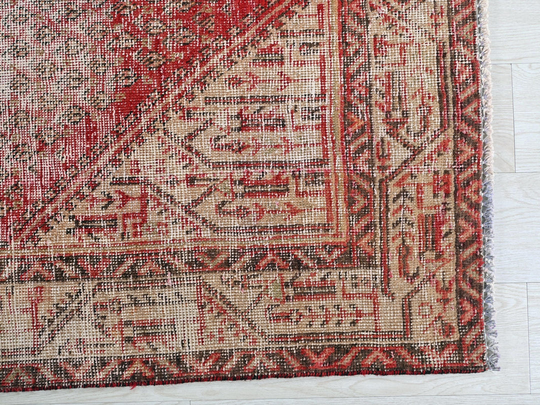 a close up of a rug on a wooden floor