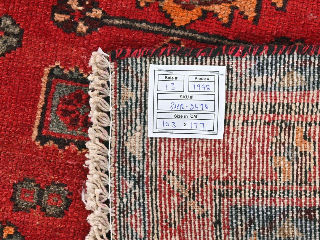 a red rug with a tag on it