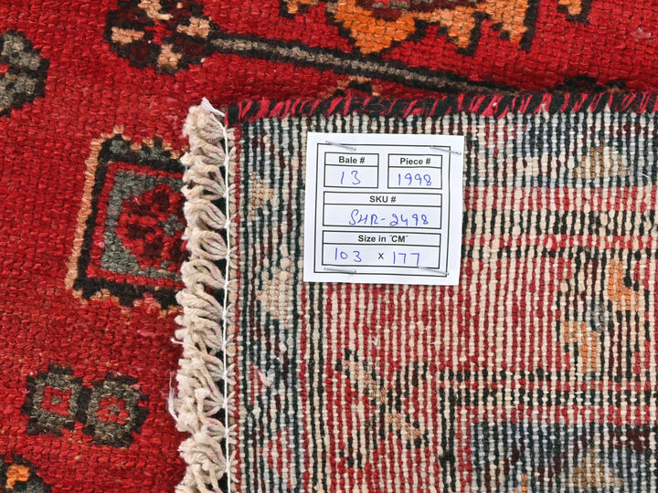a red rug with a tag on it