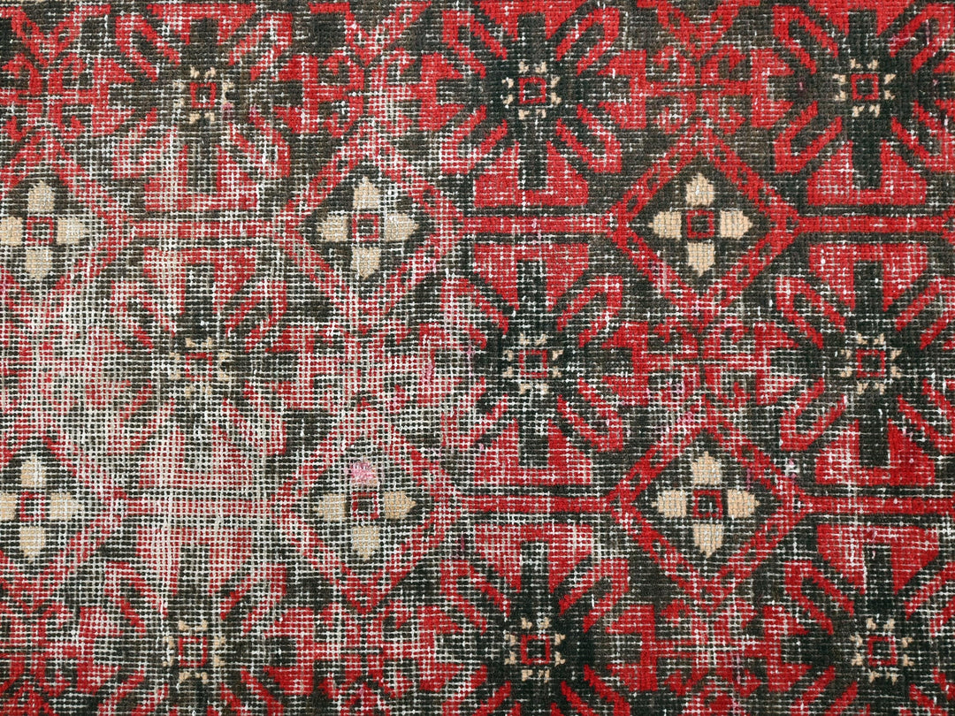 a close up of a red and black rug