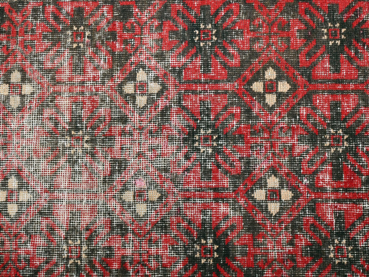 a close up of a red and black rug