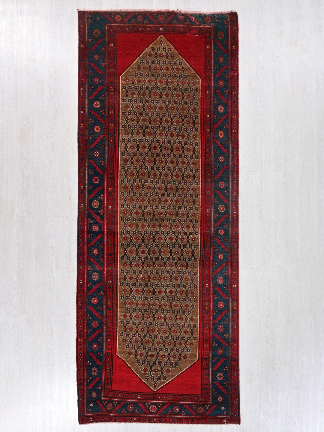 a red rug hanging on a wall