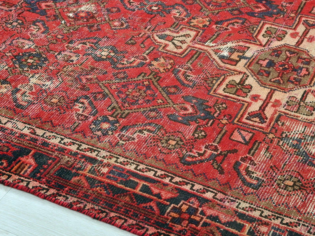 a red oriental rug with a blue border