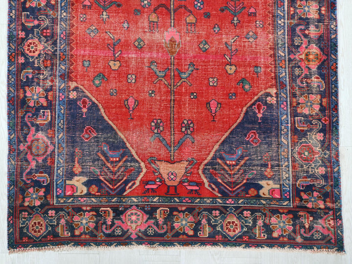 a red rug with a blue and pink design on it