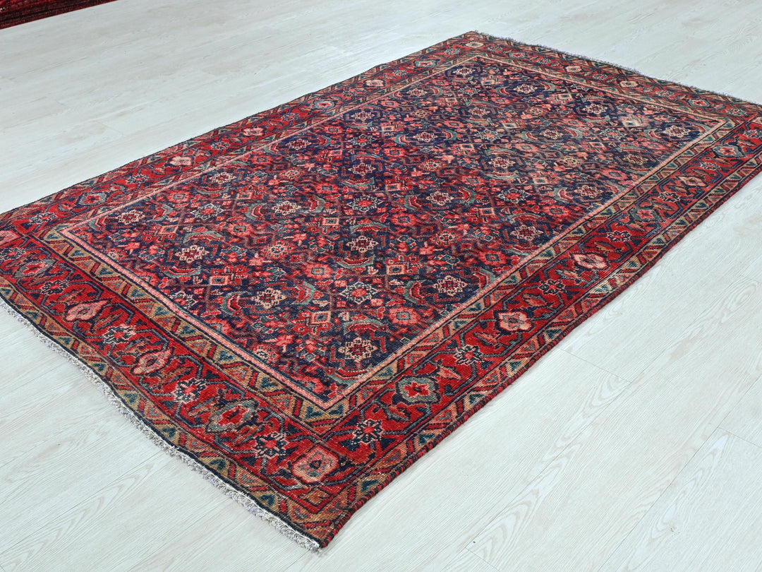 a red and blue rug on a white floor