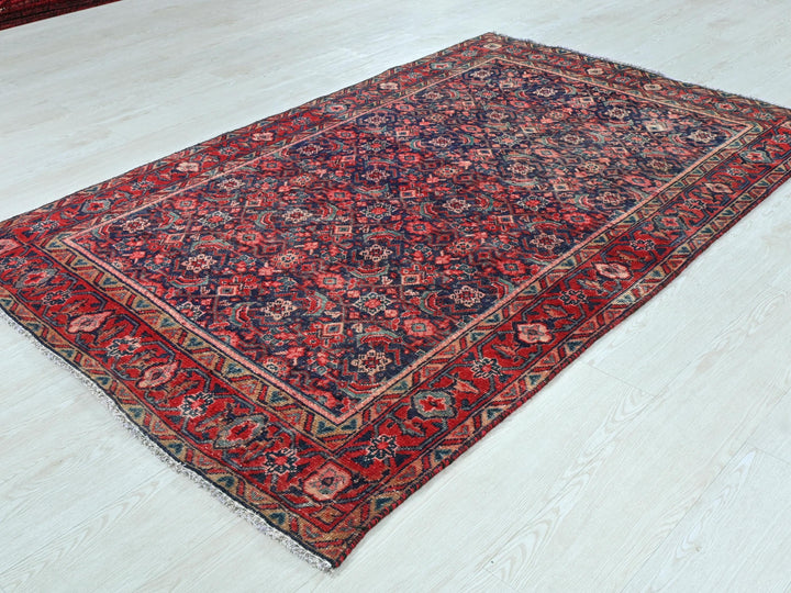 a red and blue rug on a white floor