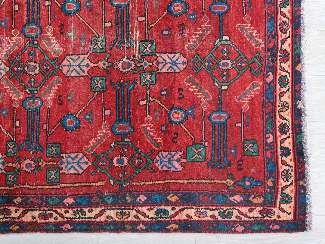 a red rug with a design on it