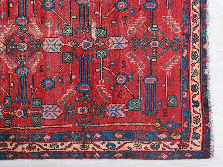 a red rug with a design on it
