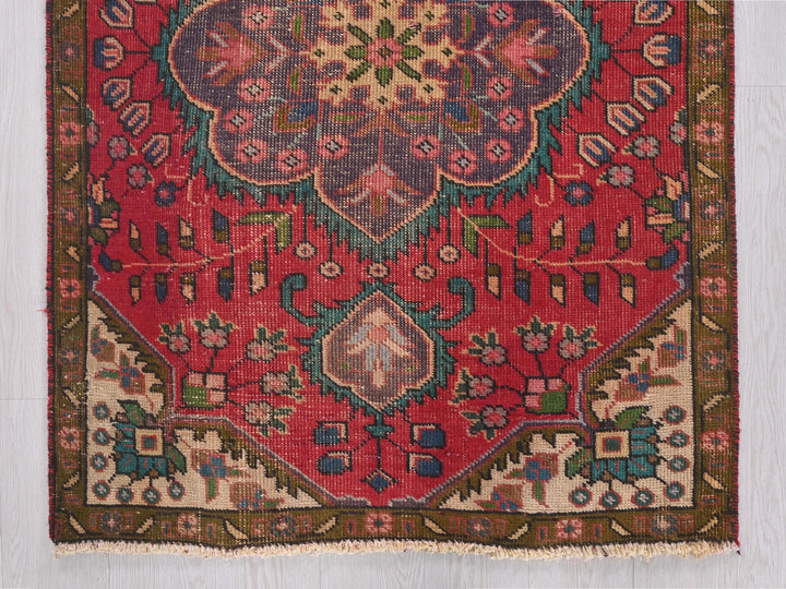 a red rug with a floral design on it