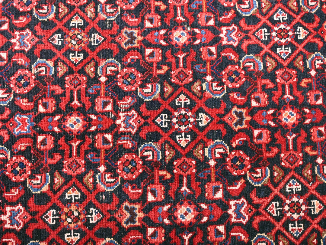a close up of a red and black rug