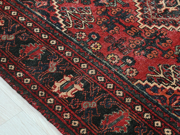 a close up of a rug on a wooden floor