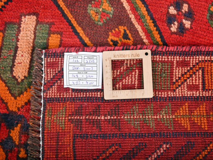 a red rug with a white tag on it