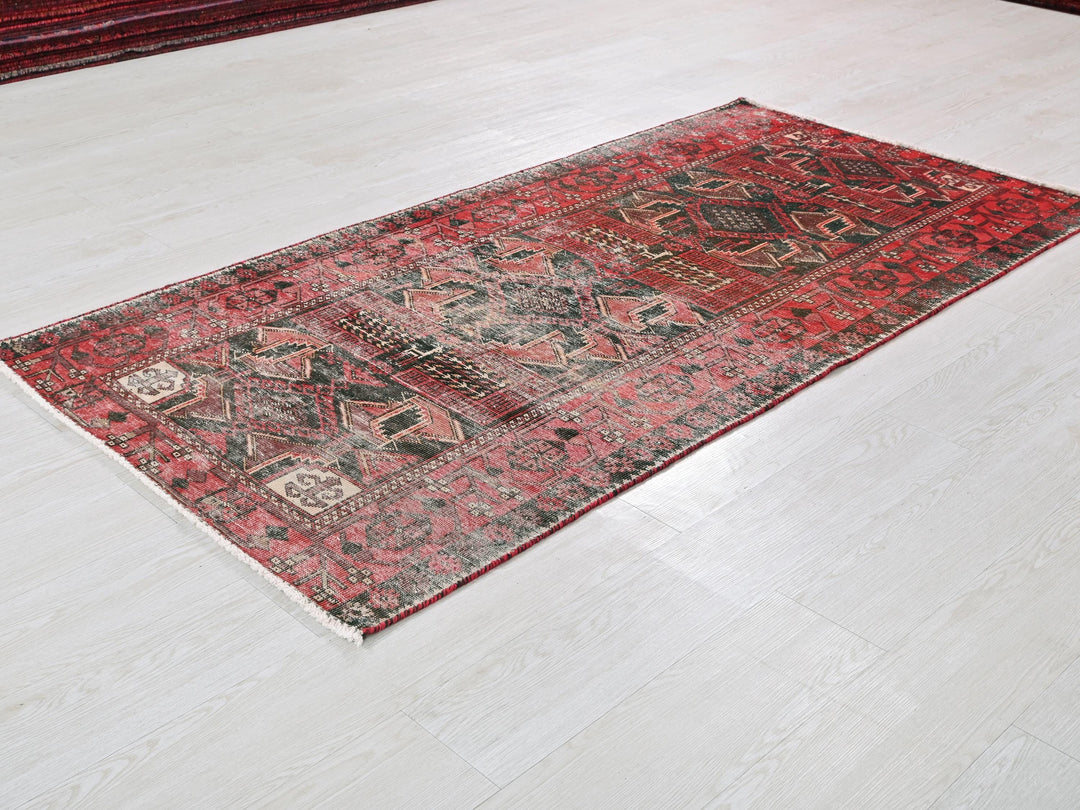 a red rug is laying on the floor